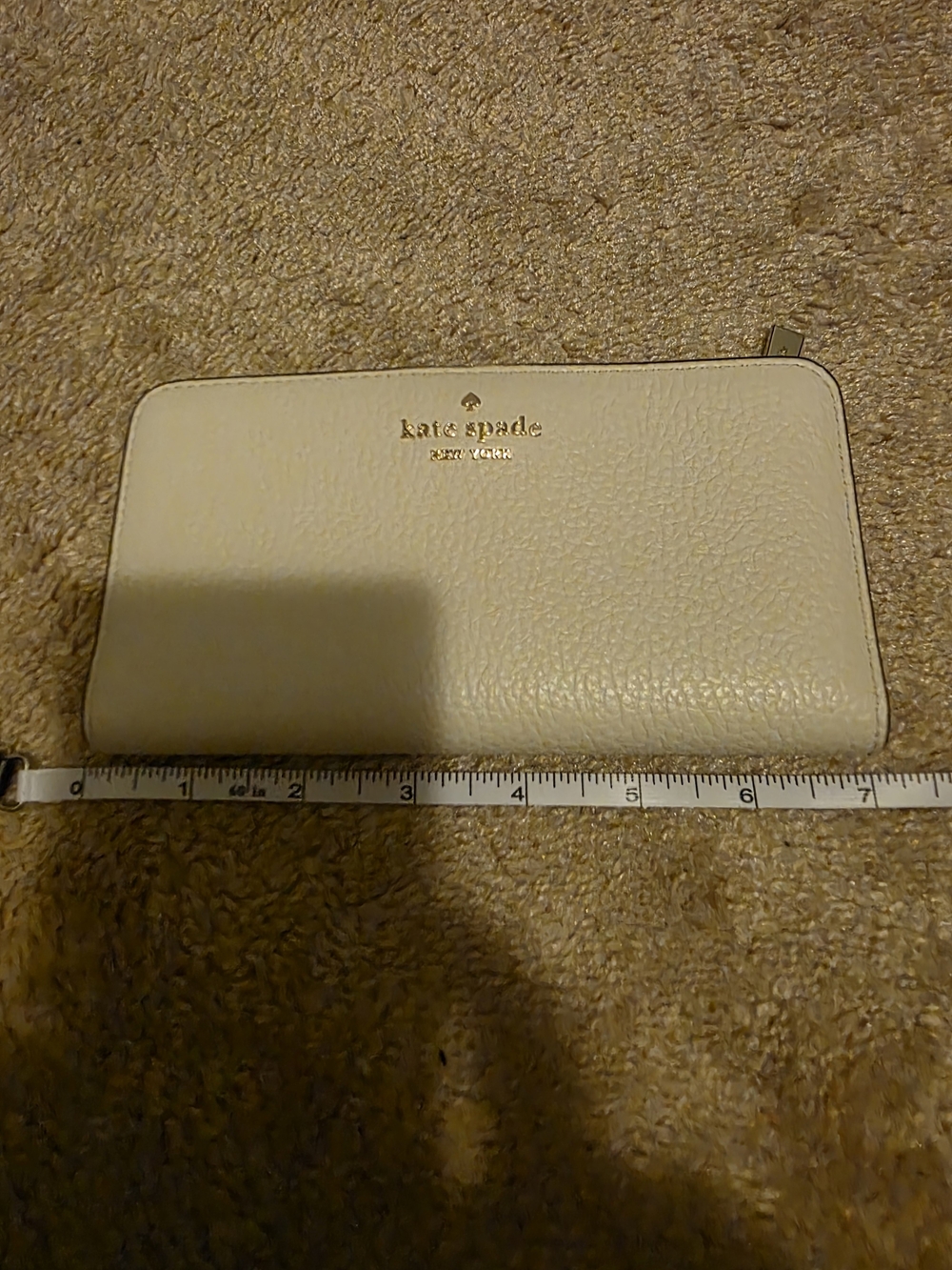 kate spade cream pebble leather zip wallet with gold logo